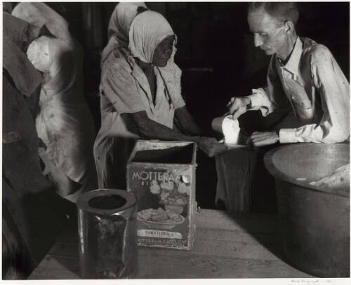 Aboriginal woman receives her food ration at Wave Hill Station, Northern Territory, ca. 1946 [picture] / Axel Poignant