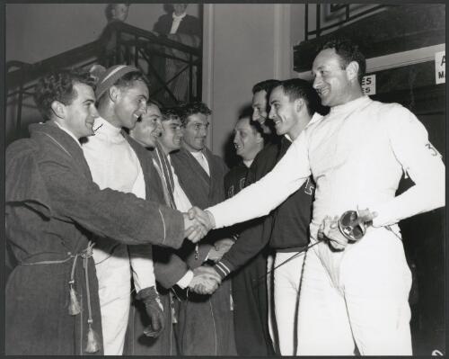 Competitors get together after the first day's fencing events at St Kilda Town Hall during the Olympic Games, Melbourne, Victoria 1956 [picture] / Bruce Howard
