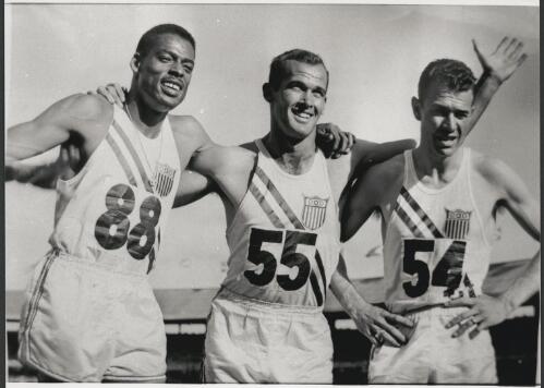 Gold medal winner Bobby Morrow, centre with Andy Stanfield and Thane Baker after the final of the 200 metres, Melbourne Cricket Ground, 27 November 1956 [picture] / Bruce Howard