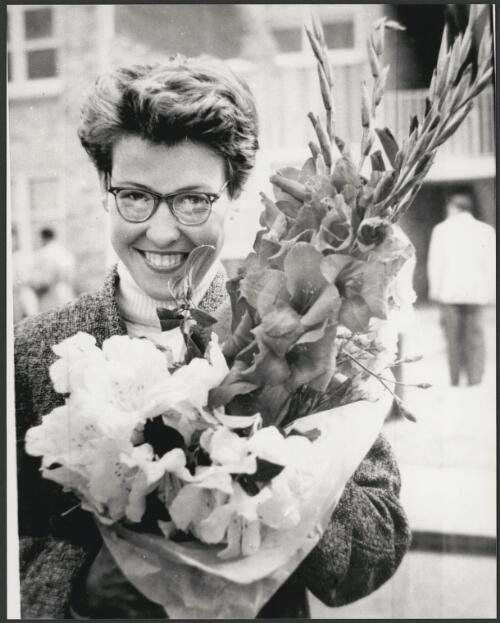 Inese Yaunzeme of USSR with flowers presented to her after her win in the women's javelin at the Olympic village, Heidelberg, Melbourne, Victoria 1956 [picture] / Bruce Howard