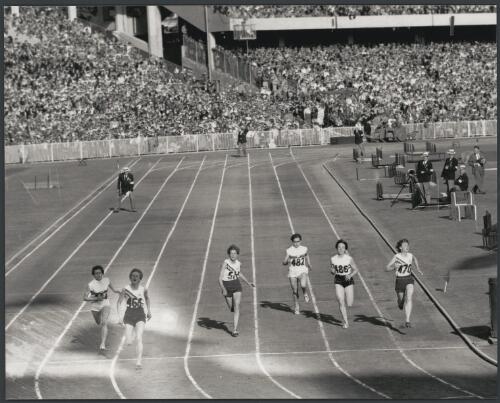 Betty Cuthbert winning the 200 metres final, Christa Stubnick of Germany taking second and Marlene Mathews of Australia taking third, Melbourne Cricket Ground, 1956 [picture] / Bruce Howard