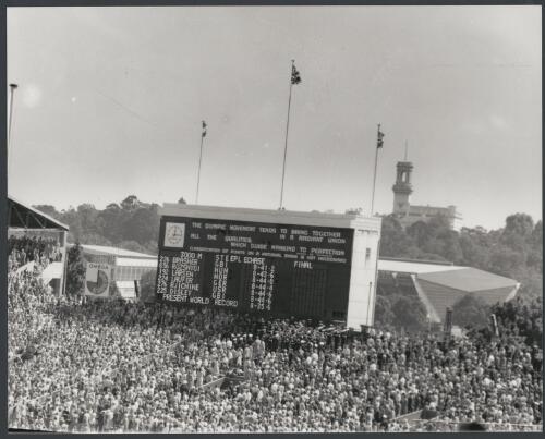Scoreboard displays results of men's steeplechase final, Melbourne Cricket Ground, 1956 [picture] / Bruce Howard