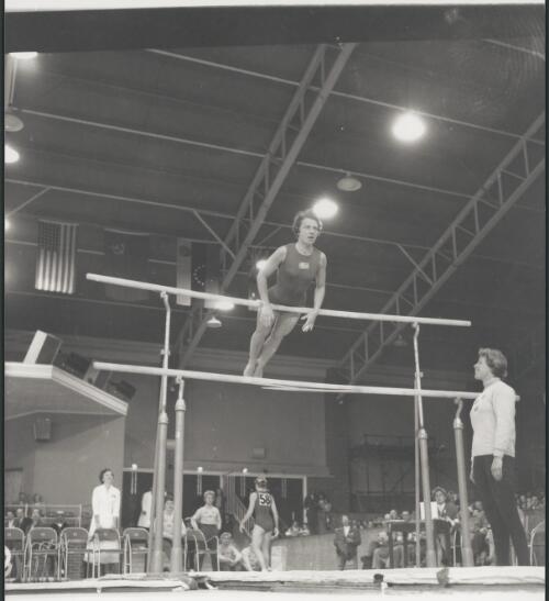 Evy Berggren of Sweden during her gymnastics routine before the splintered low bar was replaced, West Melbourne Stadium, Victoria, 1956 [picture] / Bruce Howard