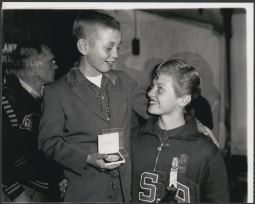 Pat McCormick with her son holding her gold medal after her win in the three metre dive, Melbourne, Victoria, 1956 [picture] / Bruce Howard