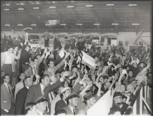 Crowds farewell Hungarian athletes before the closing ceremony, Essendon Airport, Victoria, 1956 [picture] / Bruce Howard