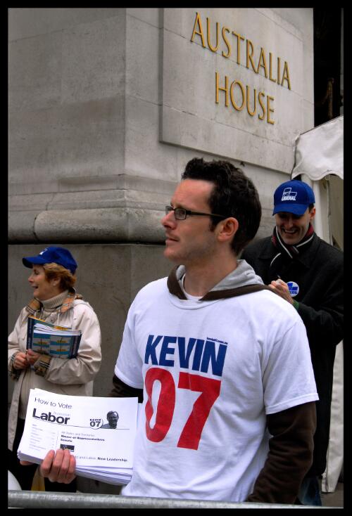 A Labor party volunteer wearing a 'Kevin 07' t-shirt, handing out campaign material for the Australian elections,  London, 2007 [picture] / Benjamin Rushton
