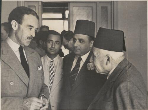 R.G. Casey, the Minister of State (left) in conversation with Dr Nimr (far right) of the Moqattam [?] on a visit with the press of Egypt, 1942 [picture]