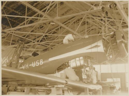 Aviation mechanics work on the Lady Southern Cross, a Lockheed Altair, at the Wheeler Field, Honolulu, Hawaii, 1934, 1 [picture]