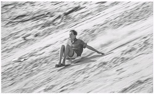 Boy sand skiing down a dune, Cronulla, New South Wales, ca.1963 [picture] / Jeff Carter