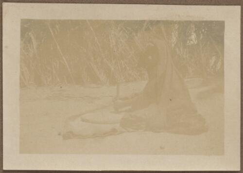 A Bedouin woman grinding grain, Egypt, approximately 1915 / W.A.S. Dunlop
