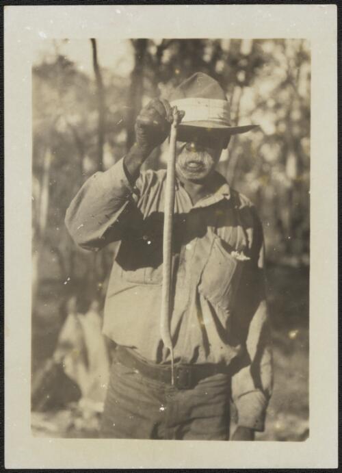 Portrait of Barney the expedition guide holding a snake, Arnhem Land, Northern Territory, 1928 [picture] / Donald Mackay