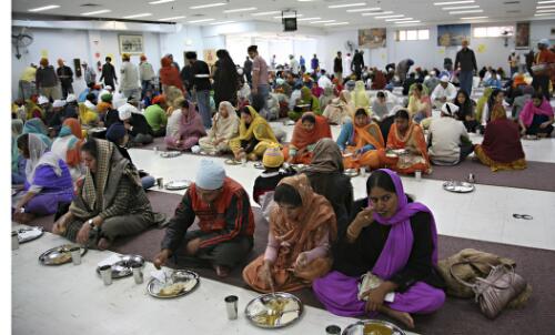 Langgar, a shared vegetarian meal, being partaken at the end of service for the congregation at the Sikh Gurdwara Temple, Blackburn, Victoria, 2007 [picture] / June Orford