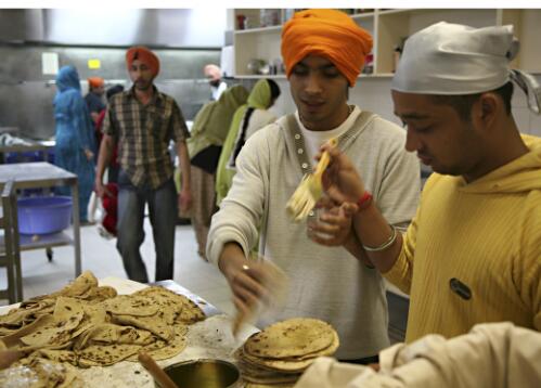 Chapatis are prepared in the Gurdwara community kitchen to be shared after the service, Sikh Gurdwara Temple, Blackburn, Victoria, 2007 [picture] / June Orford