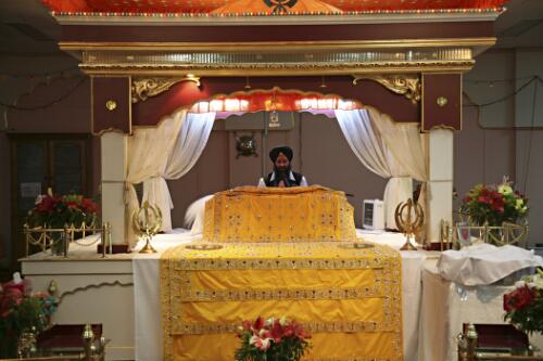 The Granthi reads from the Guru Granth Sahib, or Sikh holy scripture, Sikh Gurdwara Temple, Blackburn, Victoria, 2007 [picture] / June Orford