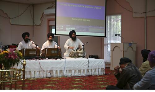 Musicians performing Keertan, the singing of Sikh hymns, accompanied by tabla, a small set of drums and harmonium, a keyboard instrument, at Sikh Gurdwara Temple, Blackburn, Victoria, 2007 [picture] / June Orford