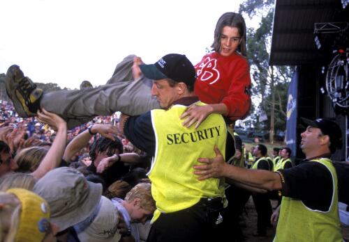 Crowd-surfing youth is assisted by security at the Falls Music and Arts Festival, Lorne, Victoria, 2000 [picture] / Martin Philbey