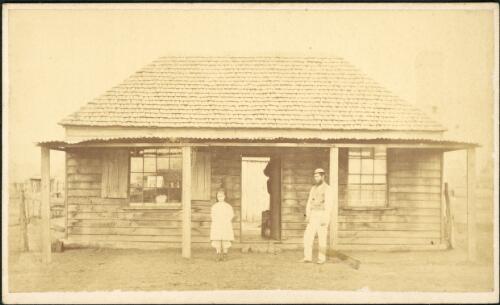 A man and child in front of weatherboard cottage with shingle roof, Hill End [?], New South Wales, ca. 1873 [picture] / Beaufoy Merlin