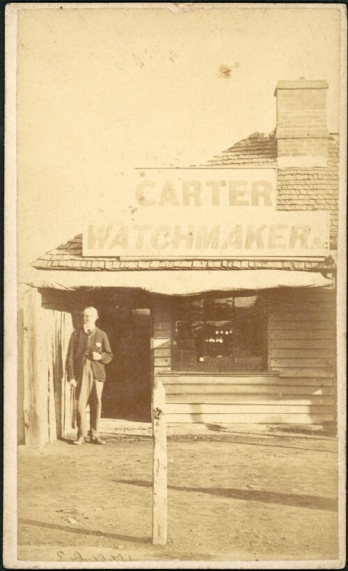 A man in front of Carter watchmaker store, Hill End [?], New South Wales, ca. 1873 [picture] / Beaufoy Merlin
