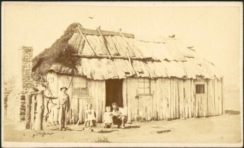 Man and children outside bark hut, Gulgong area, New South Wales, ca. 1872 [picture] / Beaufoy Merlin