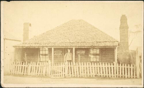 A woman standing outside the registry office, Hill End [?], New South Wales, ca. 1872 [picture] / Beaufoy Merlin