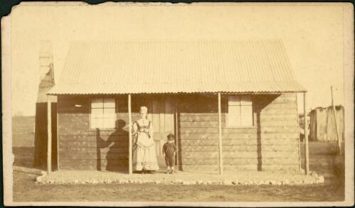 Mother and child in front of weatherboard cottage, Gulgong [?], New South Wales, ca. 1872 [picture]