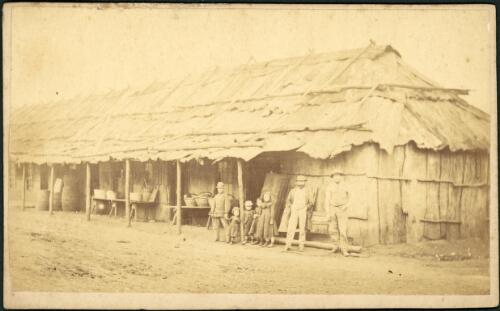 Two men and children in front of extension to Stephen E. Tuckerman's Hotel, Gulgong, New South Wales, ca. 1872 [picture]
