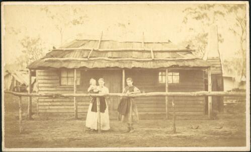 Mother and two children outside weatherboard house with bark roof, Gulgong, New South Wales, ca. 1872 [picture]
