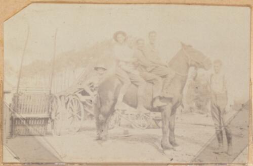 Three Australian soldiers sitting on a horse, approximately 1917