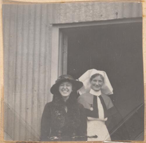 Woman and a nurse standing in a doorway, approximately 1915