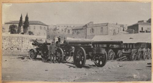 Soldier standing next to a naval gun nicknamed Nellie, Nablus, approximately 1918