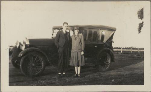On the way back from Temora, couple standing in front of vehicle, New South Wales, 1 August 1926 [picture]