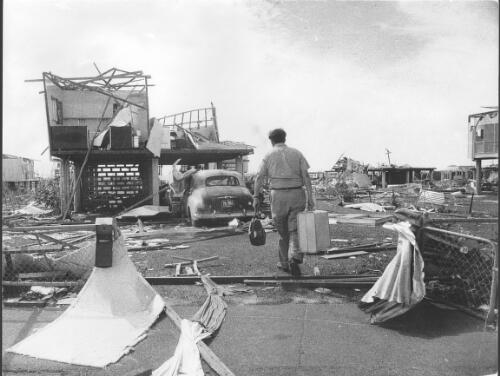 Tracy - she broke his heart : the morning after Cyclone Tracy devastated Darwin, Casuarina resident Lynn John Cox returned from holidays to his wrecked home, 1974 [picture] / Bruce Howard