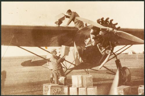 Horrie Miller (top) and Captain Jaques fuel up Miller's Fokker 4 Universal transport aircraft VH-UJT for mercy flight to pick up an ill man at Miller's Creek Station, South Australia, ca. 1930 [picture]