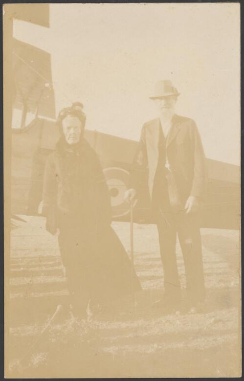 Mrs Schell and an unidentified man stand in front of Horrie Miller's De Havilland DH6 biplane C372 The Clutching Hand after a joy flight, Morgan, South Australia, ca. 1919 [picture]