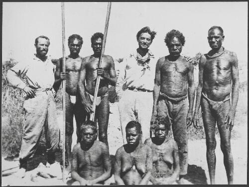Adolph Klausman, Miaman Morrit-je, Murungnunga Tour, and Captain Hans Bertram (standing from left to right) with other Aboriginal men and women after rescue, Western Australia, 1932 [picture]