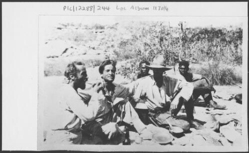 Adolph Klausmann, Captain Hans Bertram, Constable Gordon Marshall (from left to right), and two unidentified Aboriginal men sitting on the ground after rescue, Western Australia, 1932 [picture]
