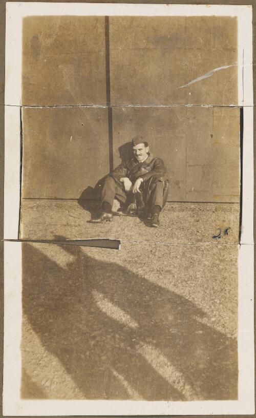 Flight Lieutenant Jack Tonbridge in military uniform sitting in the sun against a wall, ca. 1918 [picture]