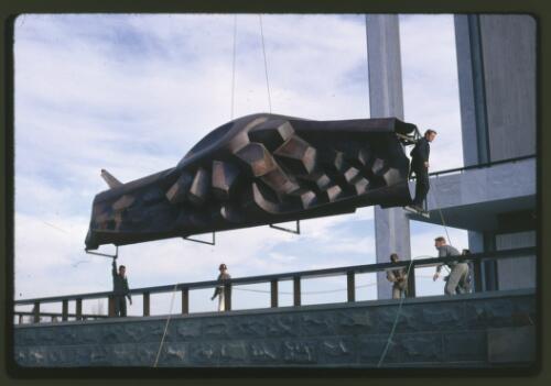 Moving the Tom Bass lintel sculpture onto the podium by crane at the National Library of Australia, Canberra, Australian Capital Territory, July 1968, 1 [transparency] / Kevin Goodridge