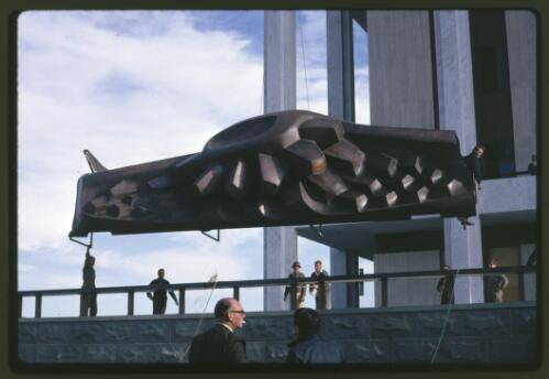 Moving the Tom Bass lintel sculpture onto the podium by crane at the National Library of Australia, Canberra, Australian Capital Territory, July 1968, 2 [transparency] / Kevin Goodridge