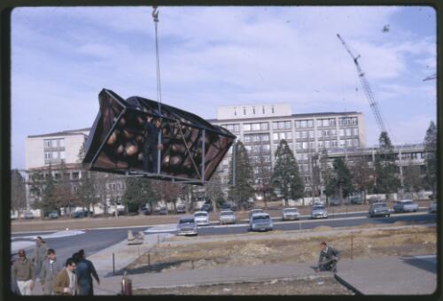 Moving the Tom Bass lintel sculpture onto the podium by crane at the National Library of Australia, Canberra, Australian Capital Territory, July 1968, 4 [transparency] / Kevin Goodridge