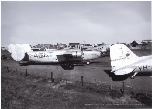 Qantas Consolidated LB-30 Liberator II passenger transport G-AGKT with another Liberator and Douglas DC-3s on tarmac at Mascot Airport, Sydney, 1946 [picture] / Russell Smith