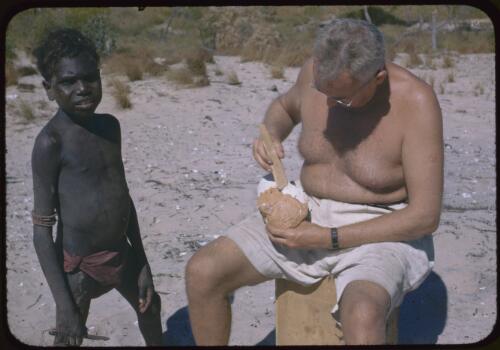 Frank Setzler taking negacol off a face cast, Groote Eylandt, Northern Territory, 7 July 1948 [transparency] / Robert Miller