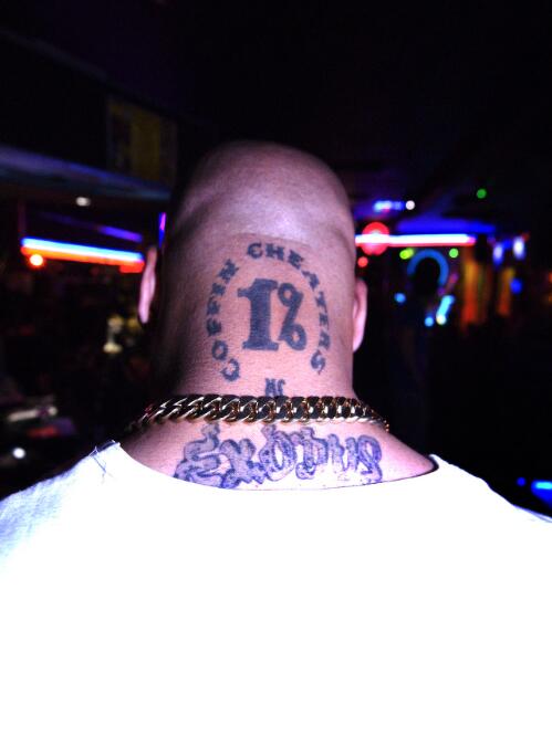 A member of the Coffin Cheaters motorcycle club shows the tattoo on his head, Voodoo Lounge, Northbridge, Perth, Western Australia, 2007 [picture] / Darren Clark