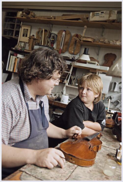 Volker Beilharz with his son Raphael in his violin workshop, as part of home schooling, Lower Templestowe, Victoria, 6 February 2008 [picture] / Dave Tacon