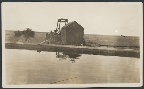 Large square stone tank at Millers Creek well, with poppet head for drawing water with buckets, South Australia, ca. 1920 [picture]