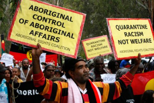 Aboriginal Australians marching with banners at the Convergence on Canberra rally against the Northern Territory Intervention, Canberra, 12 February 2008, 1 [picture] / Louise Whelan