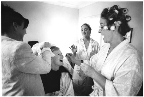 Suffering from a bout of pre-ceremony nerves, bride, Michelle Duval, recieves calming Bach remedy drops on her tongue from her mother as hairdresser and bridesmaids look on [picture] / Philip Gostelow