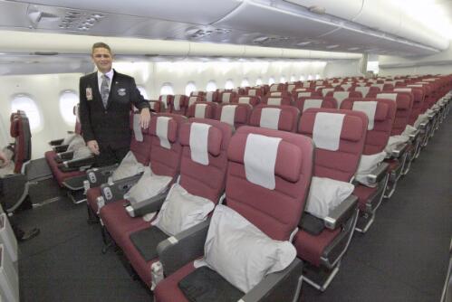 Flight attendant Frederic Boulet standing beside the Qantas A380 International Economy class seating, Sydney, 21 September 2008 [picture] / Robert James Wallace