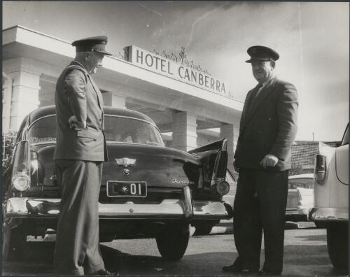 Commonwealth car drivers stand beside the Prime Ministerial car outside the Hotel Canberra in Commonwealth Avenue, Canberra, ca. 1958 [picture] / Jeff Carter