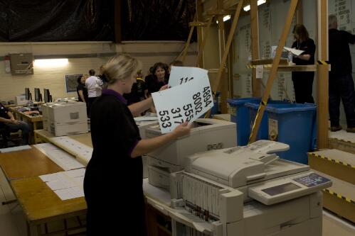 Dianne McClure from the Australian Electoral Commission retrieving the count from the printers behind the tally board during the Australian Federal Elections, Canberra, 24 November 2007 [picture] / Mark Arundel